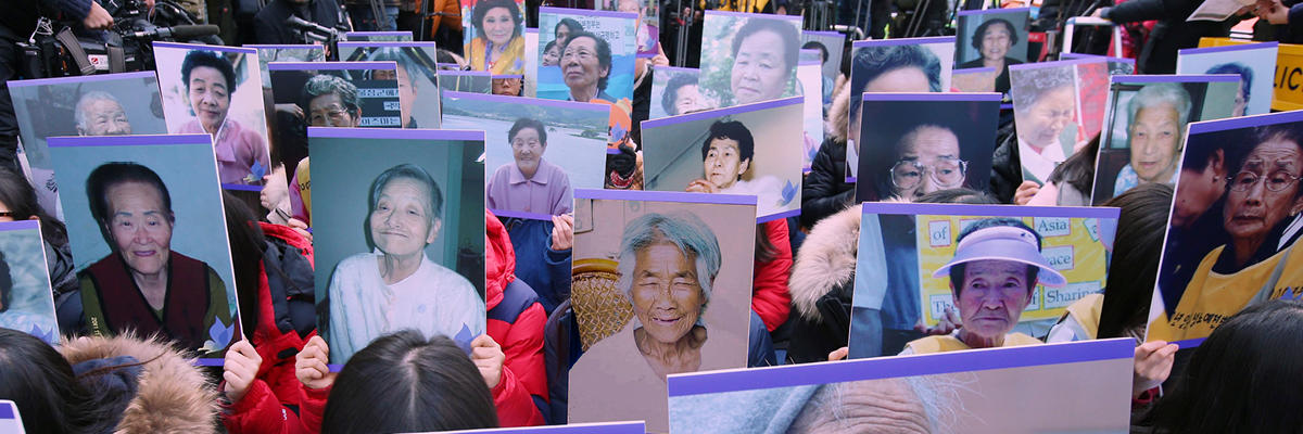 Protesters holding portraits of “comfort women”